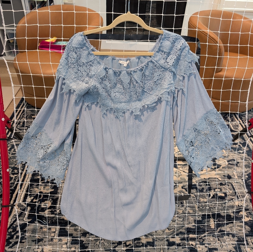 Light Blue top with lace design on sleeves and neckline